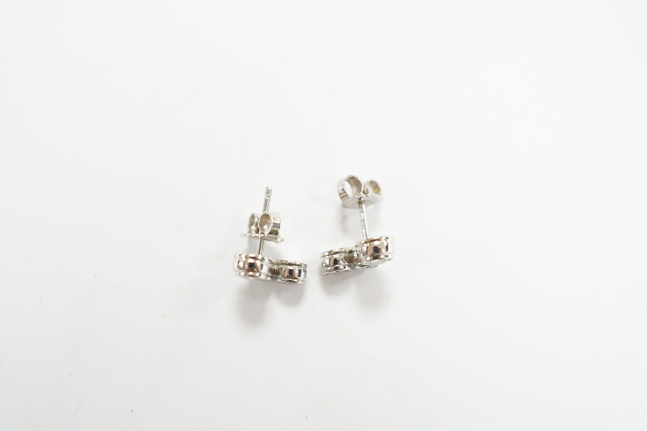 A modern pair of Tiffany & Co platinum and three stone graduated diamond set ear studs, 10mm, gross weight 4.1 grams.